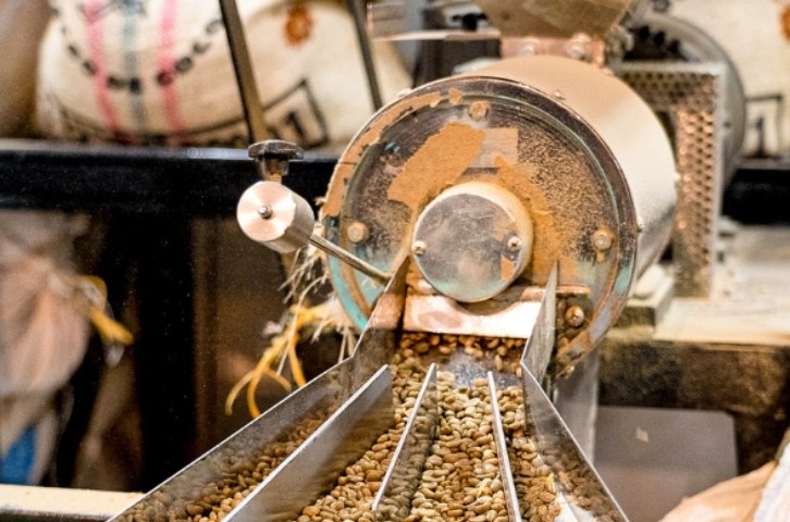 Green coffee beans moving through the milling line before export